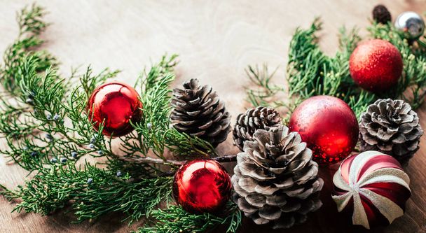 Christmas background, thuja branches, balls, cones, wooden background, copy space - Foto, imagen