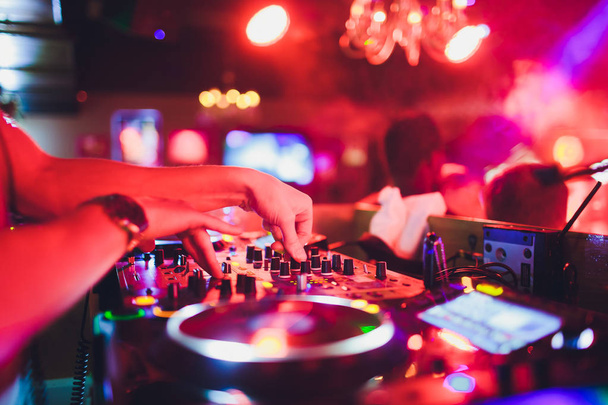 DJ hands on the remote. nightclub. DJ controlling and moving the mixers in music remote. - 写真・画像