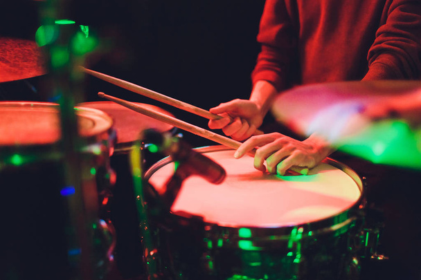 Human hands playing the drum with drumstick. - 写真・画像