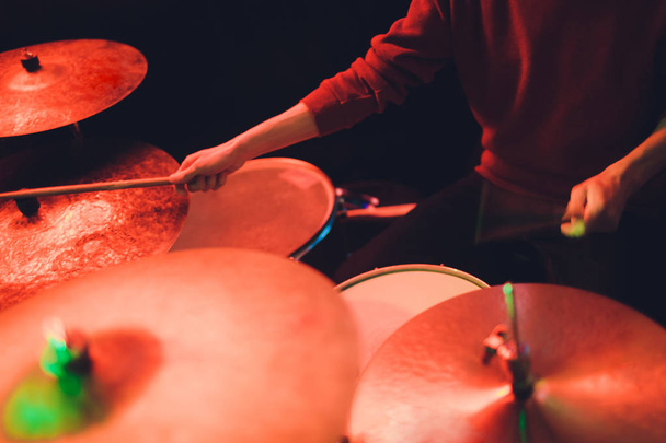 Human hands playing the drum with drumstick. - 写真・画像