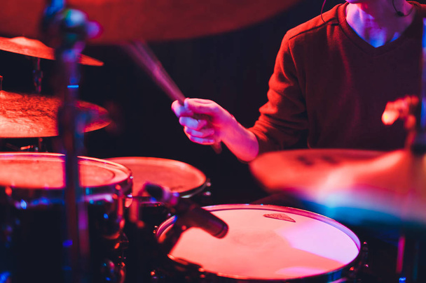 Human hands playing the drum with drumstick. - Valokuva, kuva
