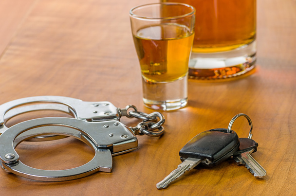 Shot glass with car keys and handcuffs - Photo, Image