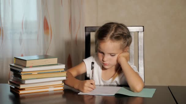 Concentrated girl doing school homework - Video