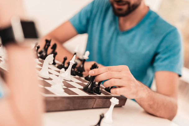 Bearded Father and Son Playing Chess on Table. Happy Family Concept. Board on Table. Young Boy in Shirt. Indoor Joy. Board Games Concept. Modern Hobby Concept. Black and White Figures. - Fotografie, Obrázek
