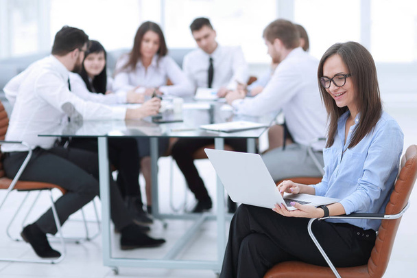 Executive businesswoman with laptop on blurred background business team - Zdjęcie, obraz