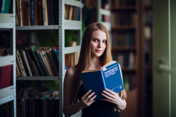 Beautiful female student in university library - Fotografie, Obrázek