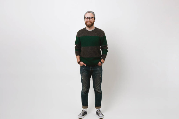 Full length portrait of cheerful smiling bearded hipster man standing over white background - Foto, imagen