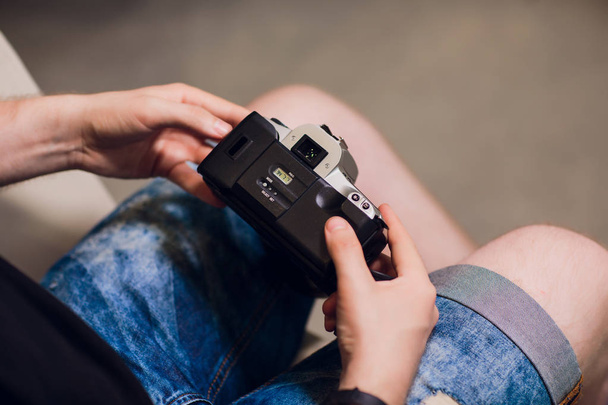 man installing photo film cartridge in film camera - Фото, изображение