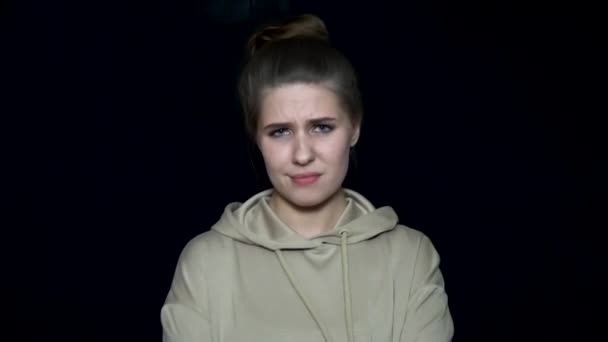 Young woman with irritated facial expression. Human facial expressions and emotions. Beautiful young woman with disappointed expression crossed her hands - Footage, Video