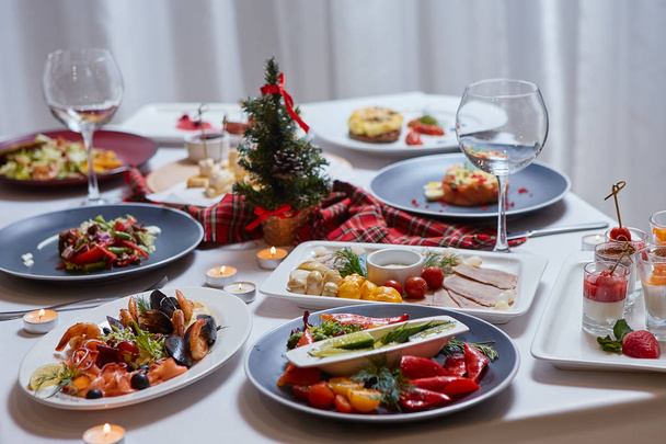 Beautifully served table with food. Festive atmosphere and decor. Celebration together - 写真・画像