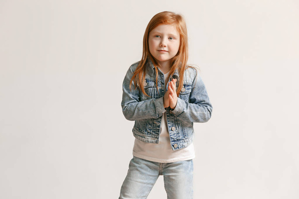 portrait of cute little kid in stylish jeans clothes looking at camera and smiling - Foto, immagini