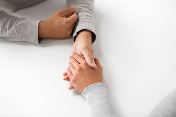 close up of young woman holding senior man hands - Foto, Imagen