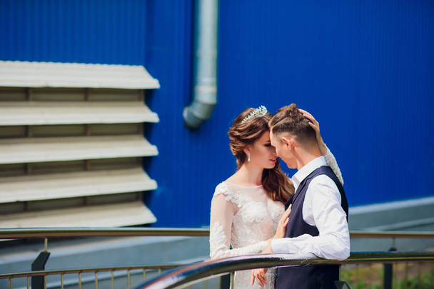 Bride and groom walking in the city, wedding day, marriage concept. Bride and groom in urban background. young couple going on a stairs in wedding day. - Photo, image