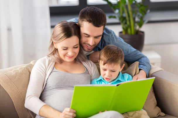 happy family reading book at home - Valokuva, kuva