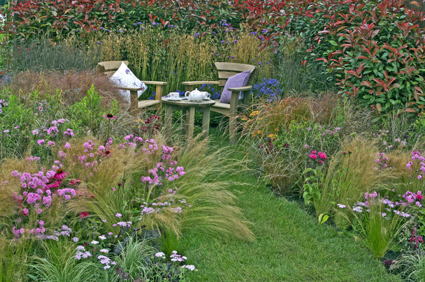 Corner of a cottage garden with display of grasses and flowers - Photo, Image