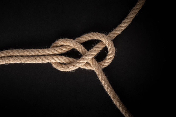 Sheet Band Knot on black background. Rope node. - Foto, immagini