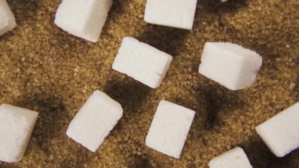 Kierto sokerikuutiot ja kristalli sokeri ylhäältä näkymä
 - Materiaali, video