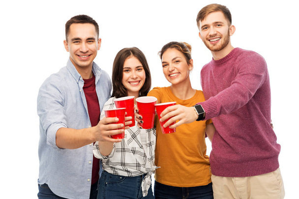 group of smiling friends with drinks in party cups - Foto, afbeelding