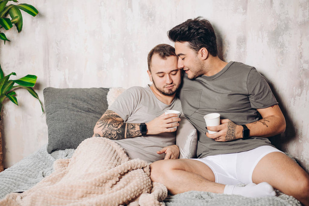 Gay Couple drinking milk Together In kitchen. Healthy Concept - Фото, зображення