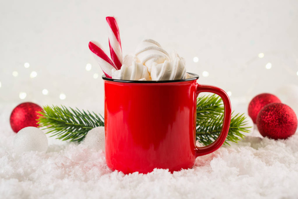 Cozy winter composition with a red cup of hot chocolate with marshmallows  on a light festive background.  - Foto, imagen