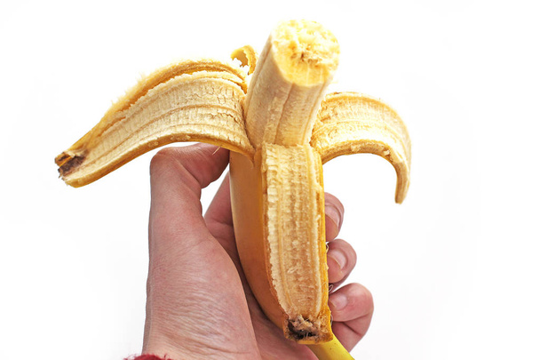 Banana in hand on white background - Foto, afbeelding