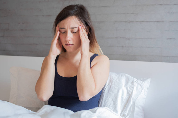 Sabahları baş ağrısı acı yatakta yatan kadın - Fotoğraf, Görsel