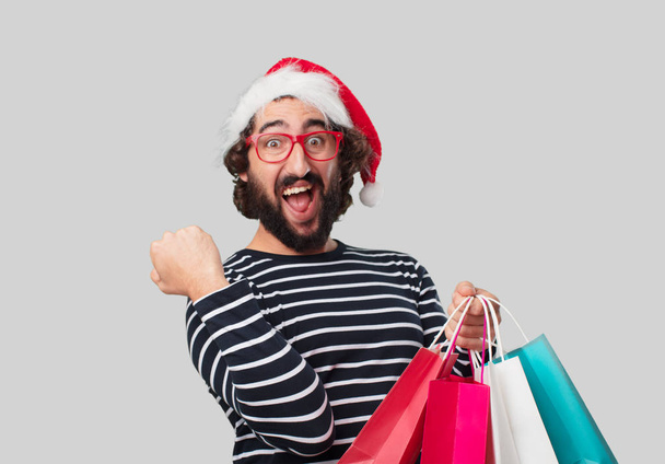 Young crazy man with shopping bags. Christmas concept. - Zdjęcie, obraz