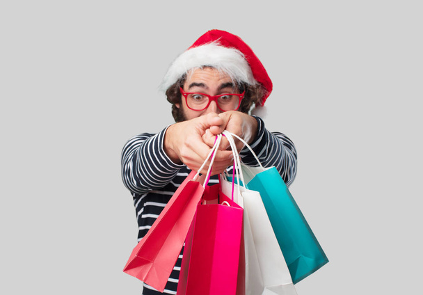 Young crazy man with shopping bags. Christmas concept. - Foto, immagini