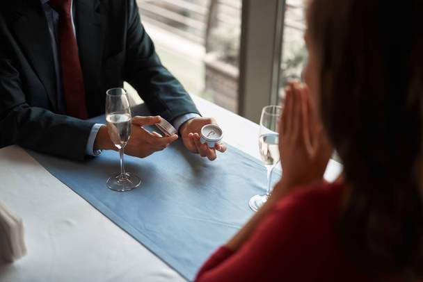 Male is making marriage proposal in restaurant - Zdjęcie, obraz