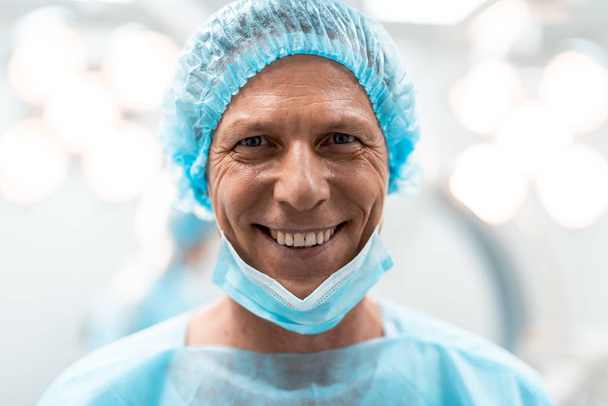 Close up of happy doctors face smiling cheerfully - 写真・画像