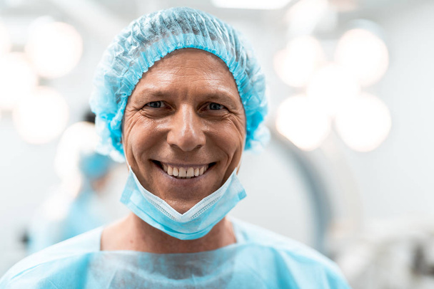 Close up of emotional doctor smiling happily after productive day - Fotografie, Obrázek
