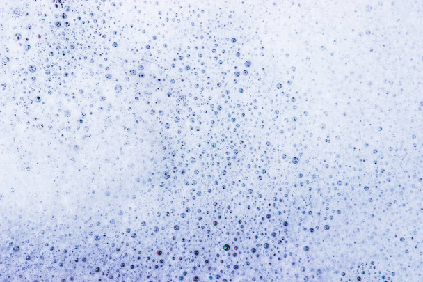 White bubble of detergent in blue container for background. Abstract texture. - Fotografie, Obrázek