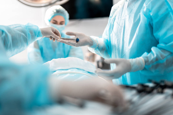 Nurse assisting the surgeon during surgical operation - Photo, Image