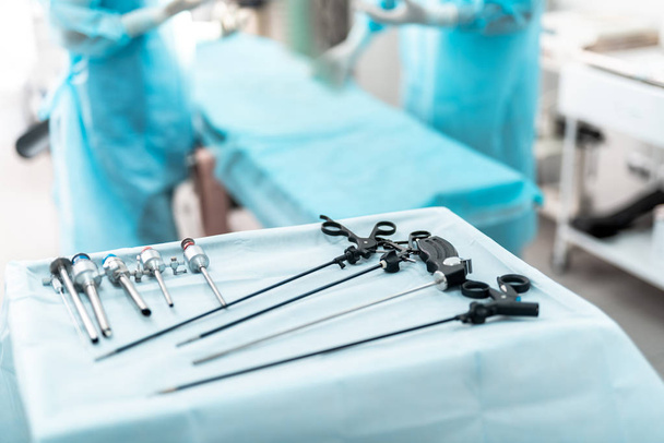 Laparoscopic surgical instruments on sterile desk in operating room - Photo, Image