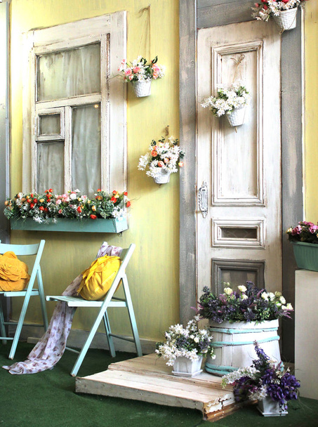 facade of the old house in bright colors decorated with flowers vintage style - Foto, Imagem