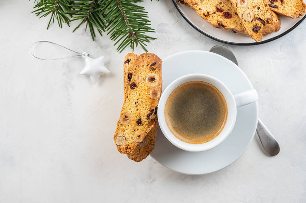 Christmas homemade cookies biscotti with dry berries and cup of coffee. - Photo, image