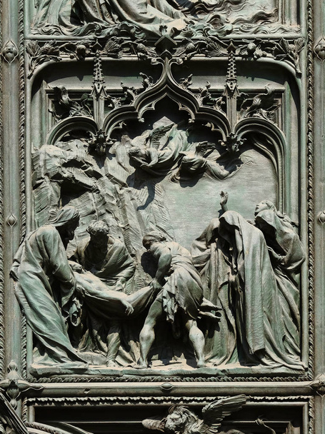 Jesus is laid in the tomb, detail of the main bronze door of the Milan Cathedral, Duomo di Santa Maria Nascente, Milan, Lombardy, Italy - Фото, зображення