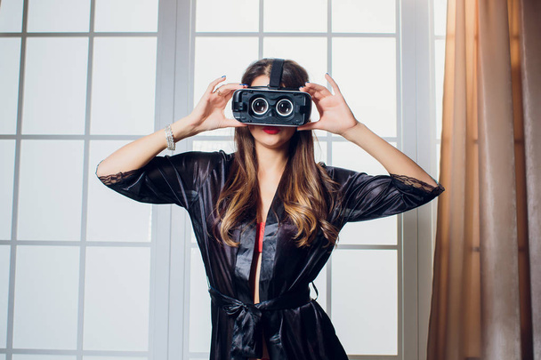 Beautiful woman wearing Lingerie using vr-goggles in bed. - Foto, Imagem