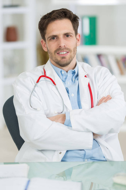 handsome young doctor at work in his office - Photo, image