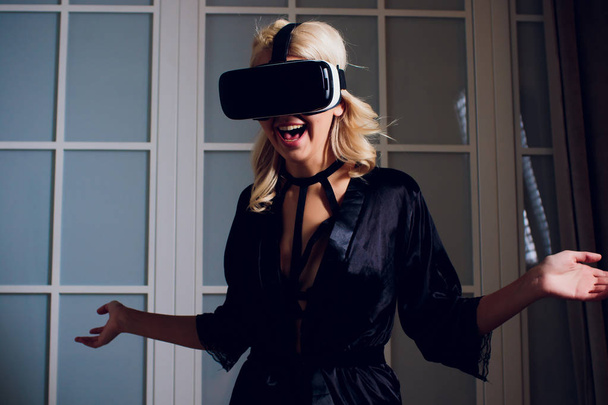 Beautiful woman wearing black Lingerie using vr-goggles. - Foto, Bild