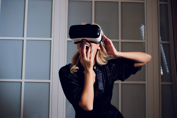 Beautiful woman wearing black Lingerie using vr-goggles. - Photo, image