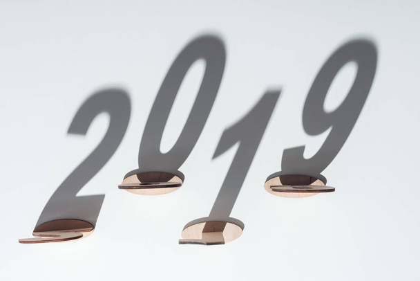 top view of wooden numbers with 2019 shadow on white background - Photo, Image