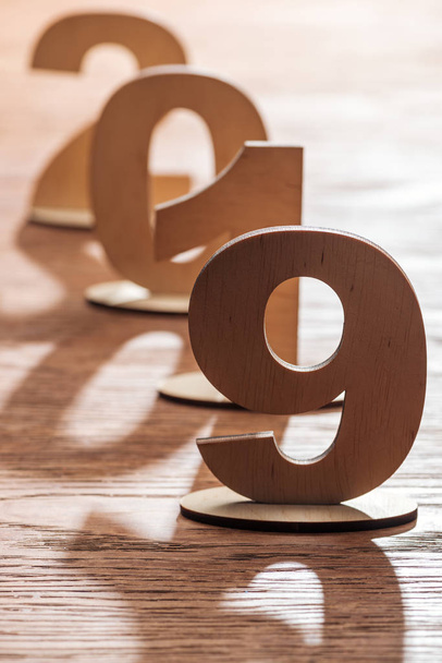 selective focus of 2019 date made of plywood numbers with shadows on wooden tabletop - 写真・画像