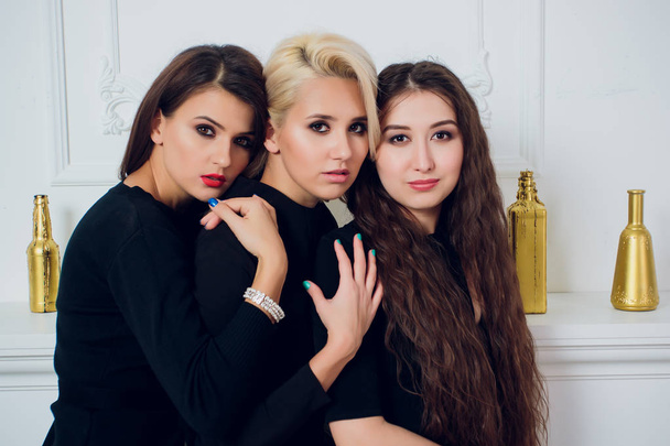 Three playful attractive young women white background. - Φωτογραφία, εικόνα
