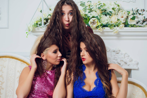 Three playful attractive young women white background. - Fotografie, Obrázek