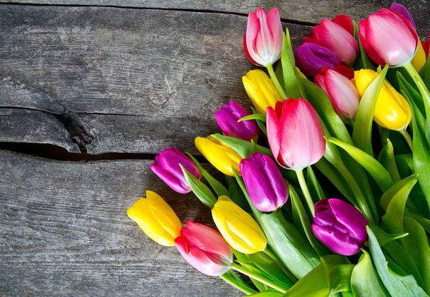 colorful tulips on wooden surface - Zdjęcie, obraz
