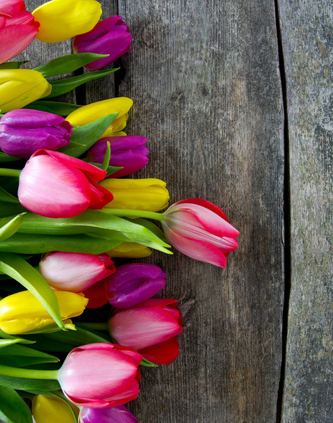 colorful tulips on wooden surface - Foto, Imagen