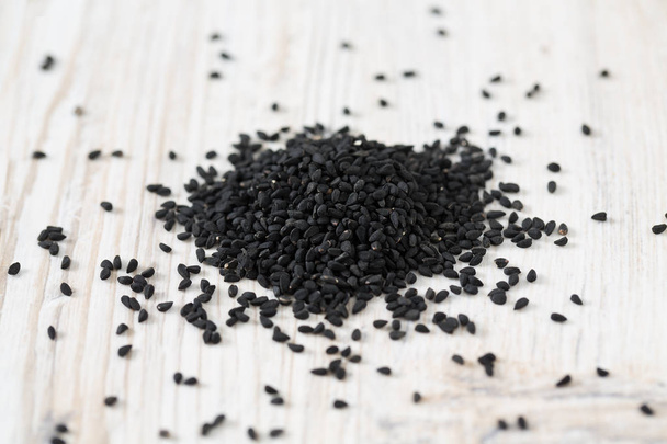 black cumin on wooden surface - Foto, Imagen