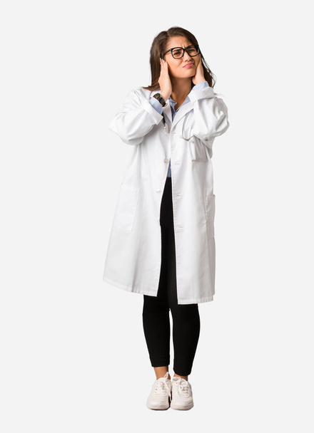 Full body young doctor woman covering ears with hands - Foto, immagini