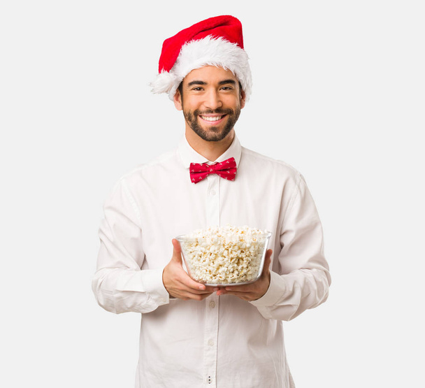 Young man wearing a santa claus hat on Christmas day - Photo, Image